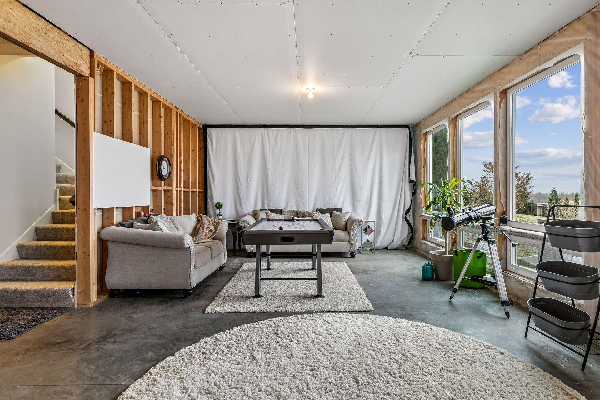 Welcome to the lower level—tall ceilings and wide-open space make it feel anything but unfinished.