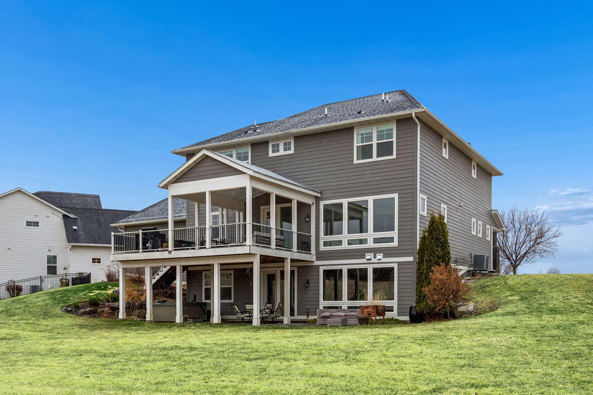 A beautiful view of the home’s rear elevation, showcasing the walkout lower level and expansive decking.