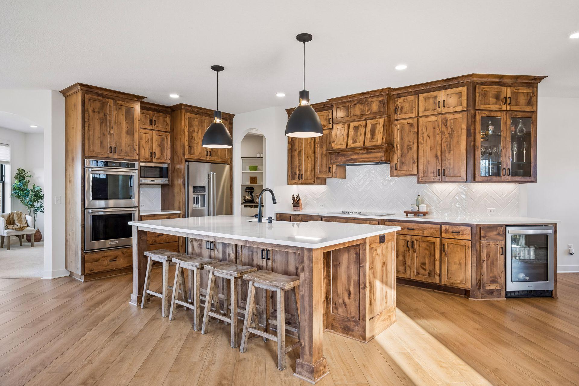 Stunning custom kitchen with large center island, tile backsplash and walk-in pantry.