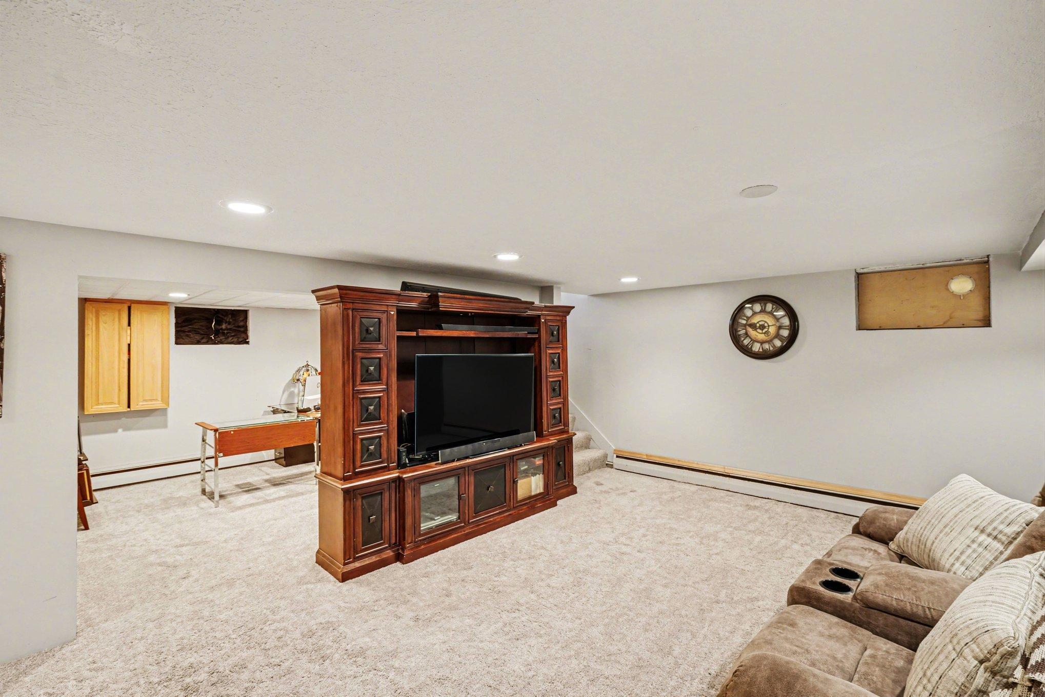 Lower Level Family Room, with game or office area beyond entertainment stand
