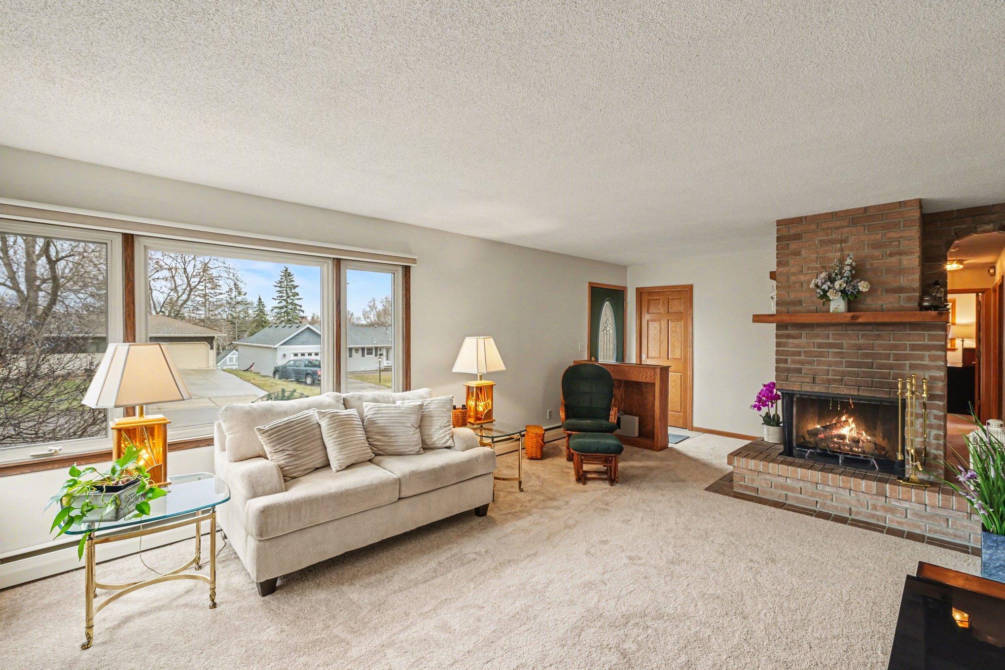 The Living Room features a beautiful two sided fireplace.