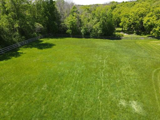 The tree lined pasture creates tremendous privacy