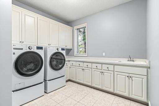 Large main level laundry with amazing cabinet and counter space