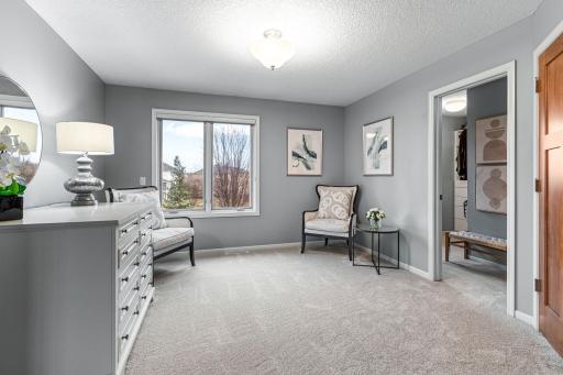 Spacious primary bedroom complete with a sitting area and walk-in closet