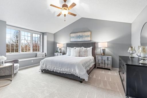 The primary suite boasts vaulted ceilings and a cozy reading nook