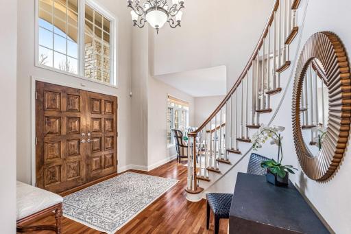 Grand entrance features double wood doors and a chandelier