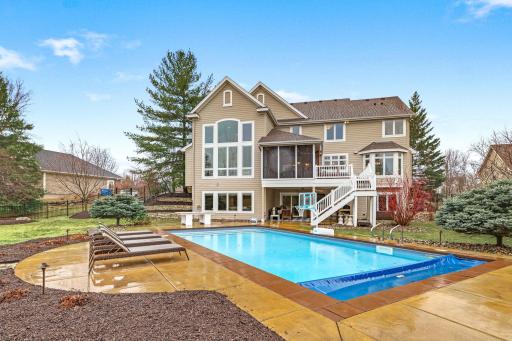 Back exterior of the home with an in-ground pool!