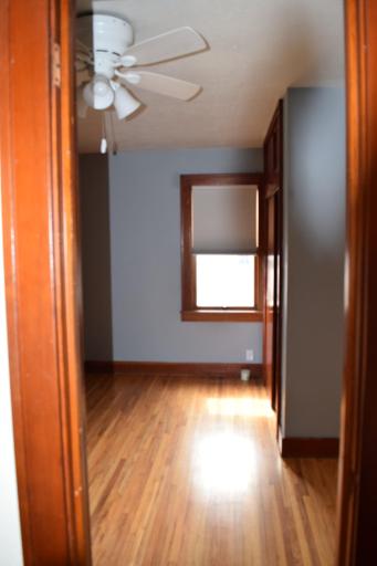 Bedroom just off the living room and hardwood floors continue here