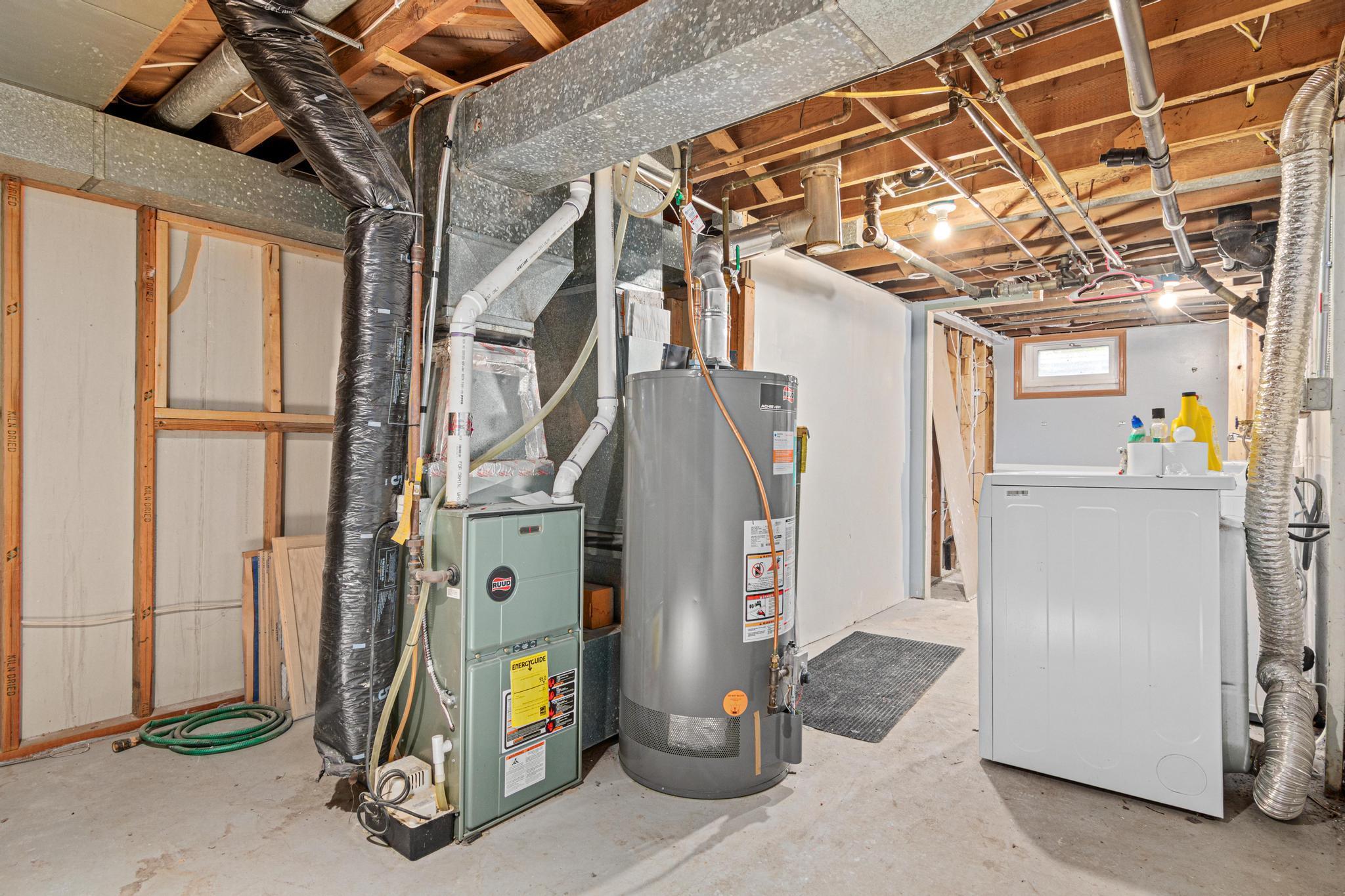 Utility room with washer, dryer and bathroom rough-in