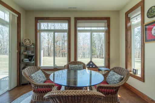 Sunroom, View of Backyard Leading to Golf Course Begins at Tree Line
