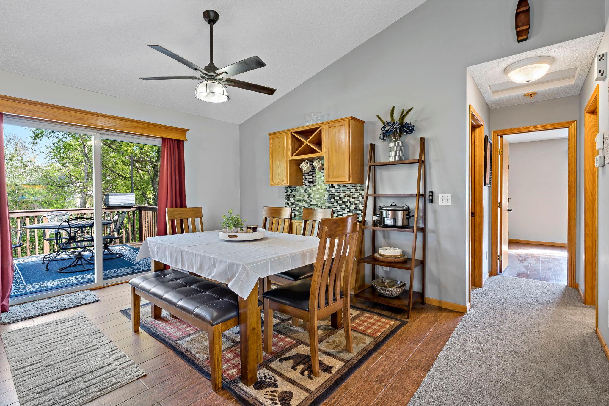 Dining area with patio door leading to deck and fenced in back yard.