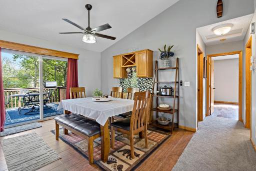 Dining area with patio door leading to deck and fenced in back yard.