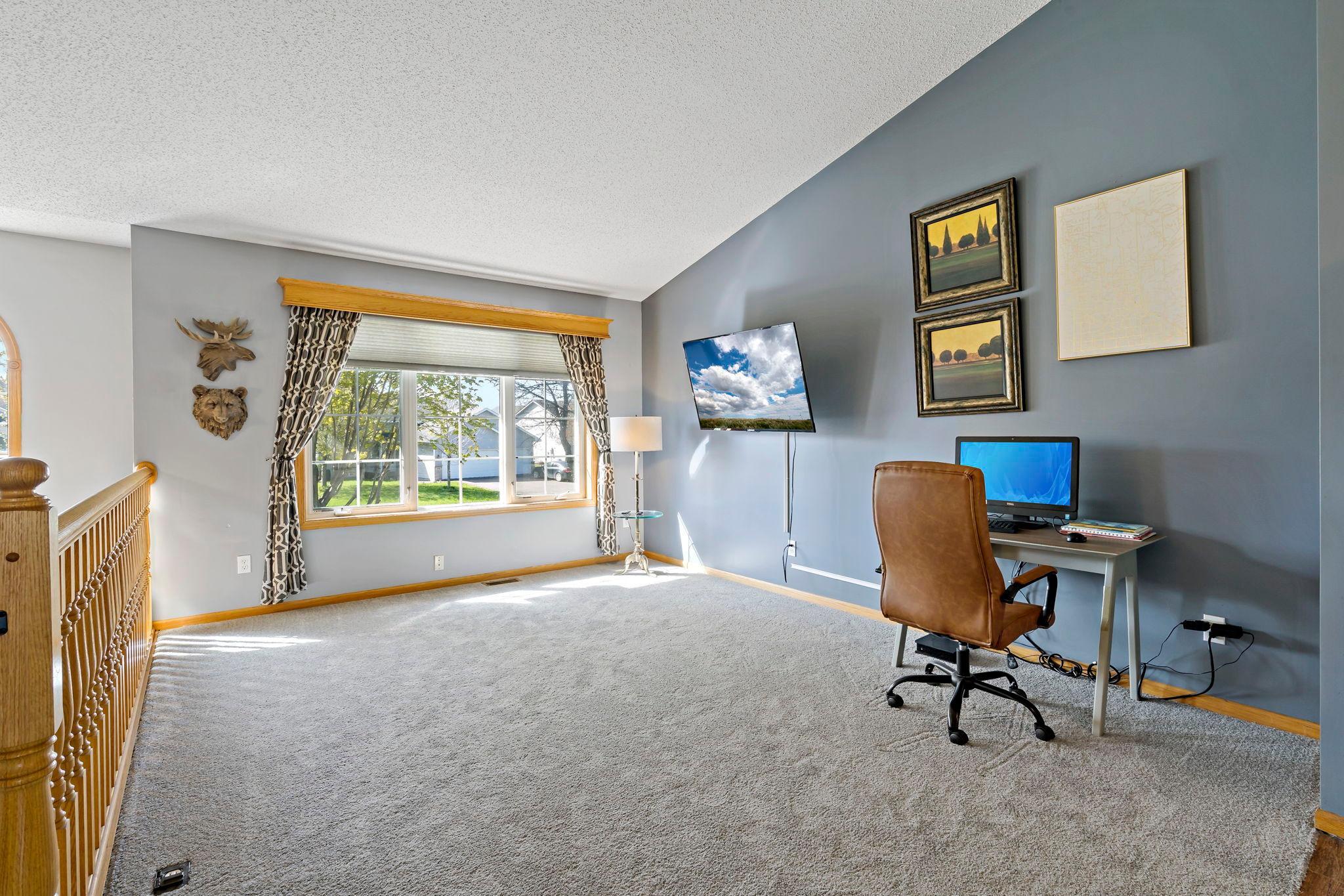 Living room Lots of sunlight, vaulted ceilings and brand new carpet
