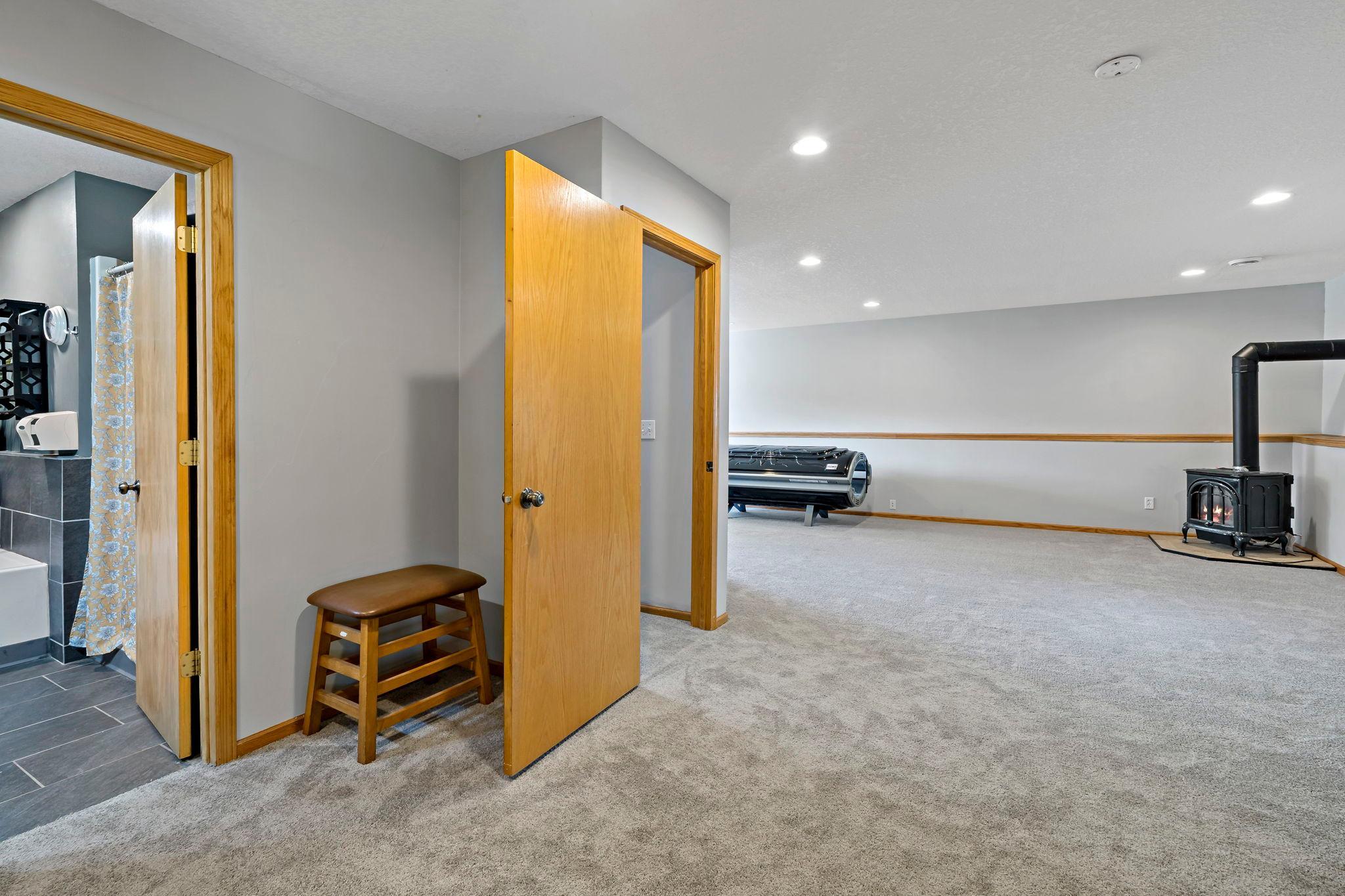 L shaped Family room in lower level with gas fireplace and brand new carpet