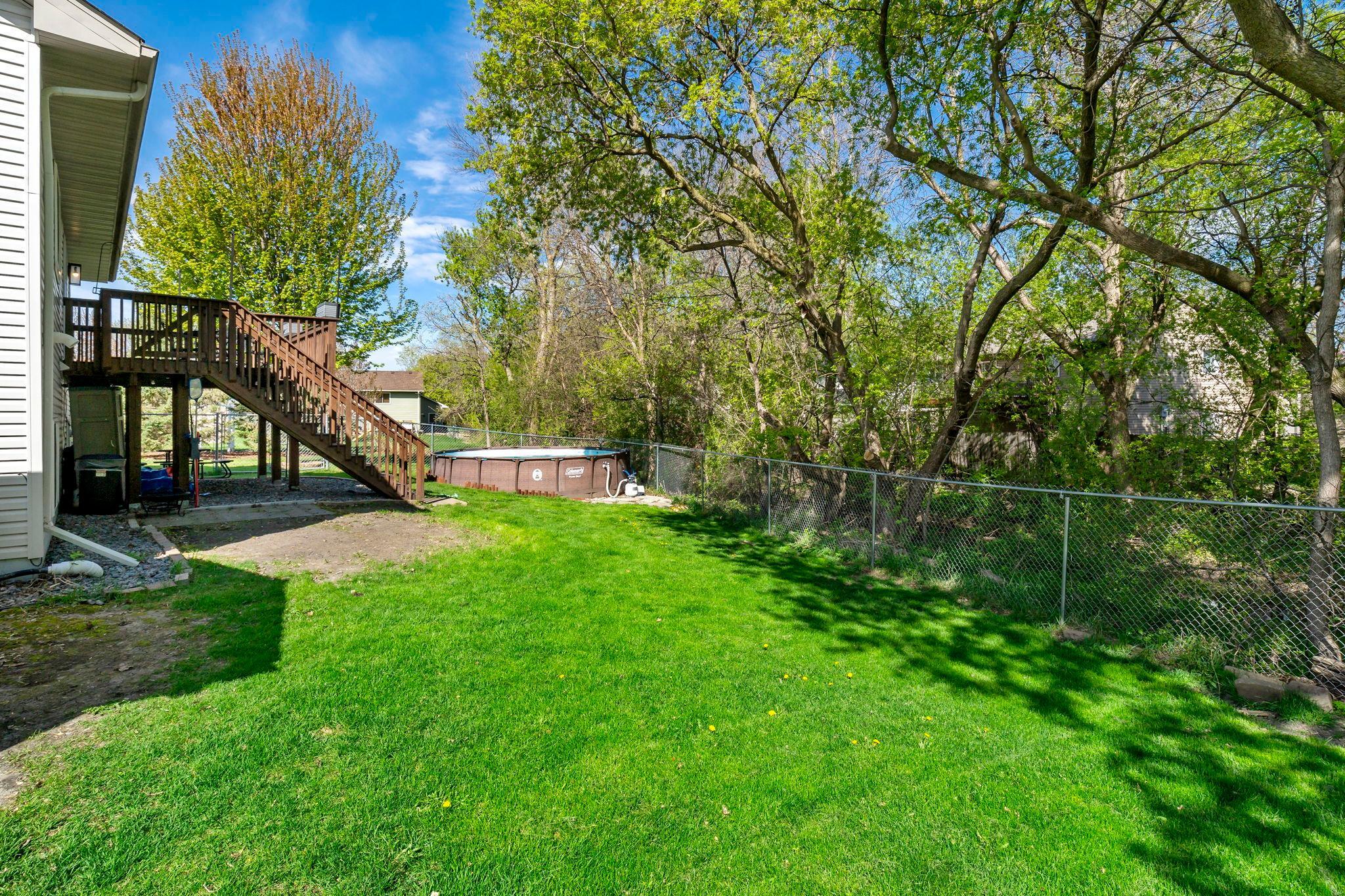 Fenced in back yard with above ground pool.