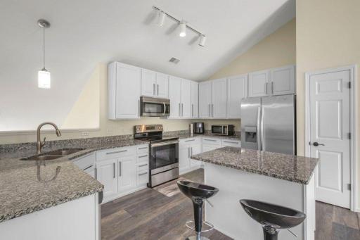 2 Gorgeous kitchen with enameled cabinertry, center island, granite counters, stainless appliances and more.JPG