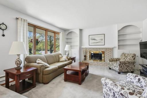 Living Room featuring gas fireplace and large bright windows.