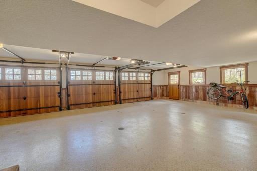In addition to custom cedar doors, heated epoxy floor, and barn wood siding, this attached 3-car garage also has the best ever dog-washing station.