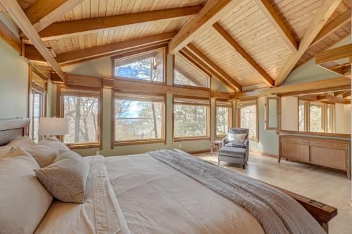 The primary suite on the upper level has gorgeous views towards the lake.