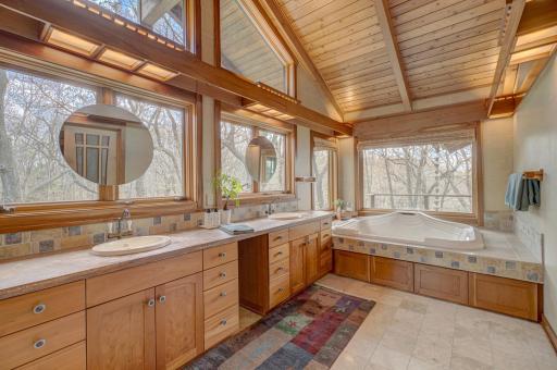 The primary bath has a soaking tub, steam shower, separate toilet area, and expansive views!