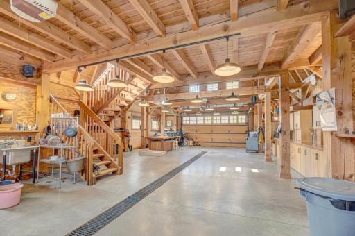 Inside the timber frame barn, vehicle space, workshop space, heated floors, floor drain.