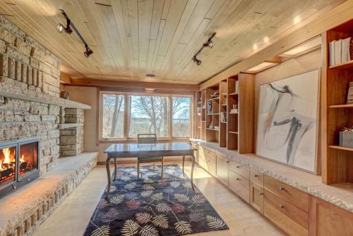 The office with its wood-burning fireplace and generous built-in storage.