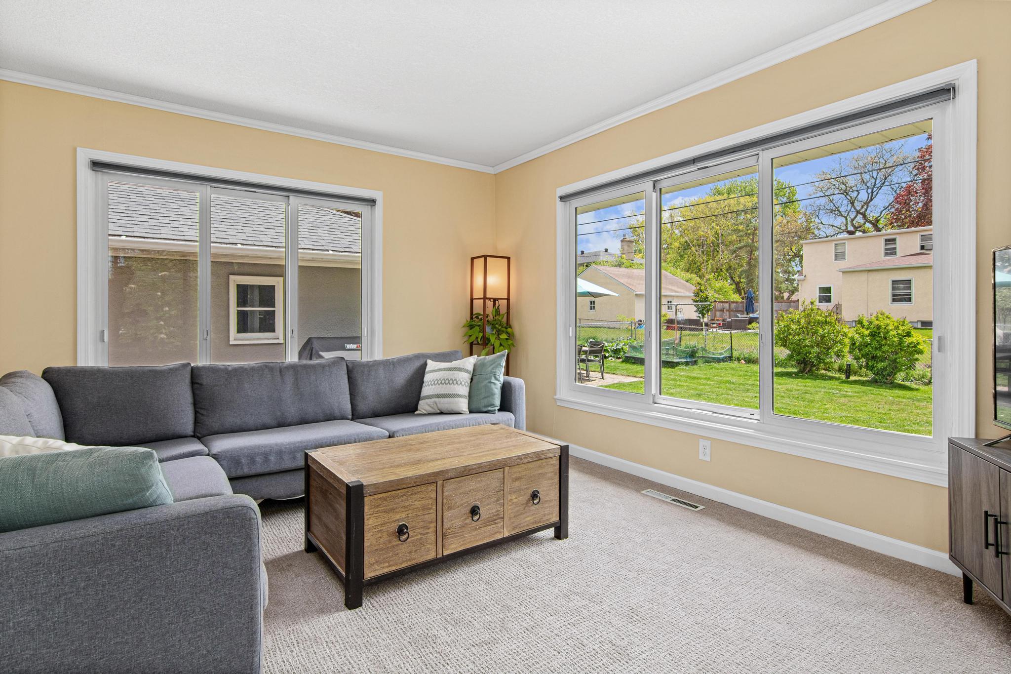 Large windows overlook the fully fenced back yard.