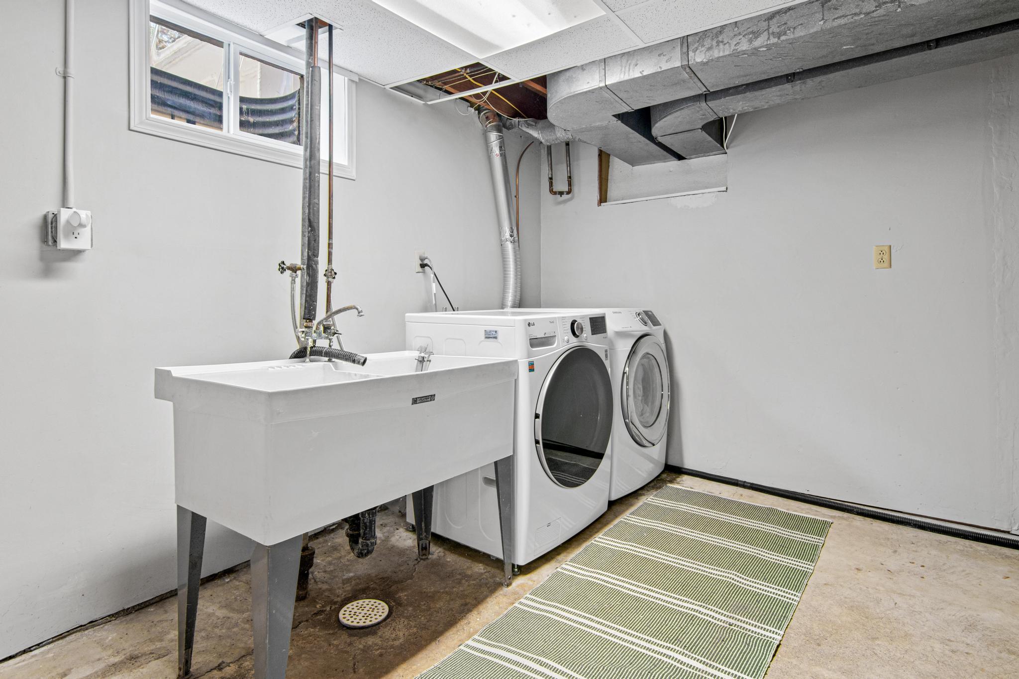 Lower level laundry room wraps around to the right of the photo with excellent storage space. There are also 2 separate storage rooms in the basement.