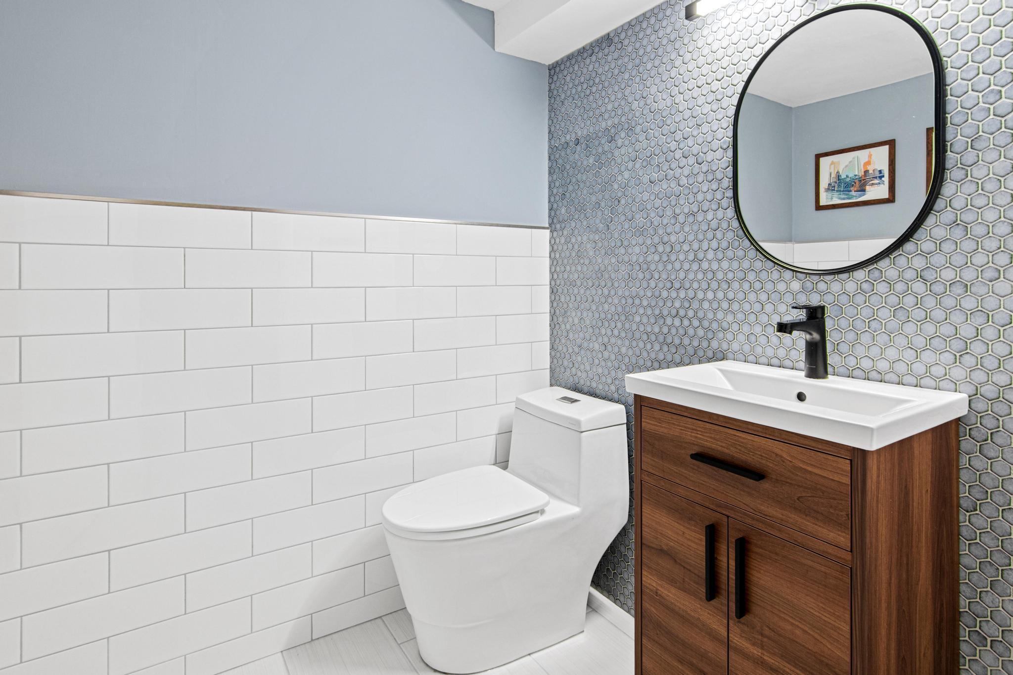 The lower level powder bath got a major glow up in 2024 with a full remodel.