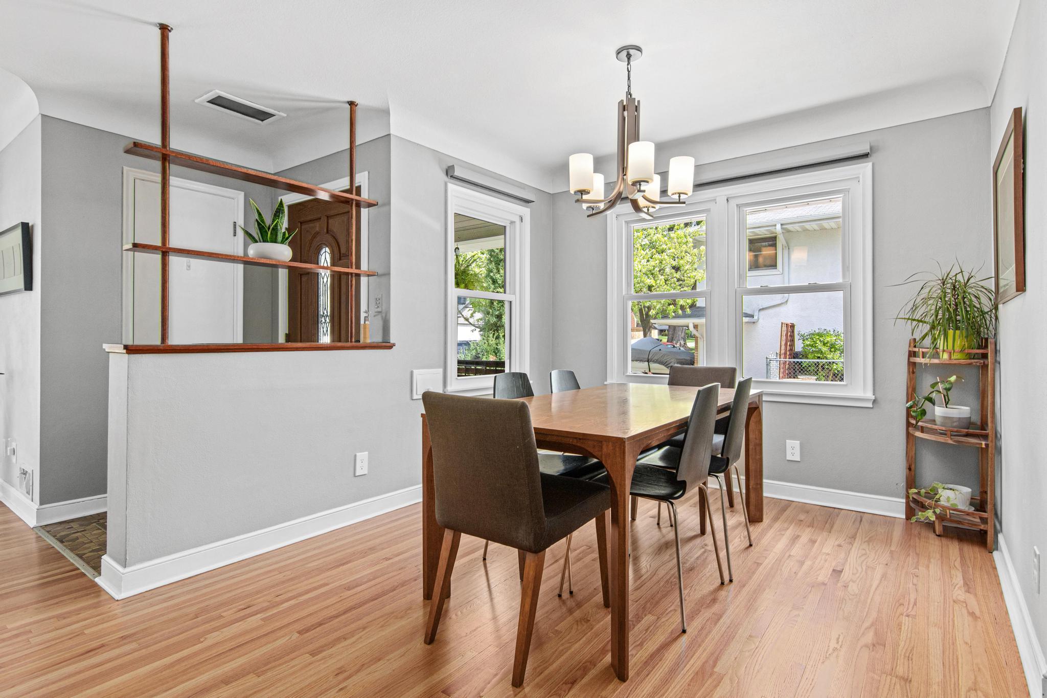 The dining room features newly refinished hardwood floors, triple pane windows and an updated light fixture.