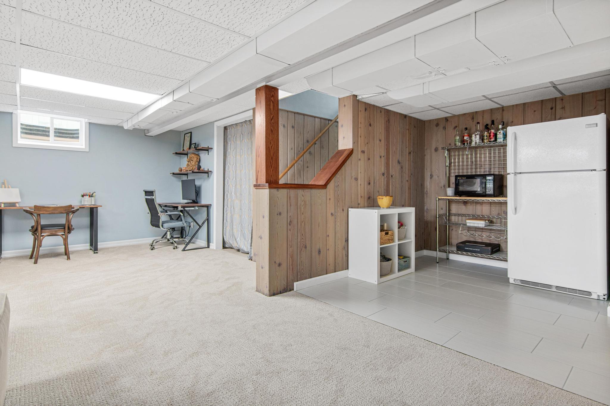 The owners tiled this area of the family room in 2024 and is an excellent spot to build out a bar, create a kitchenette, or use as a designated zone for arts and crafts since the floors are easy to clean.
