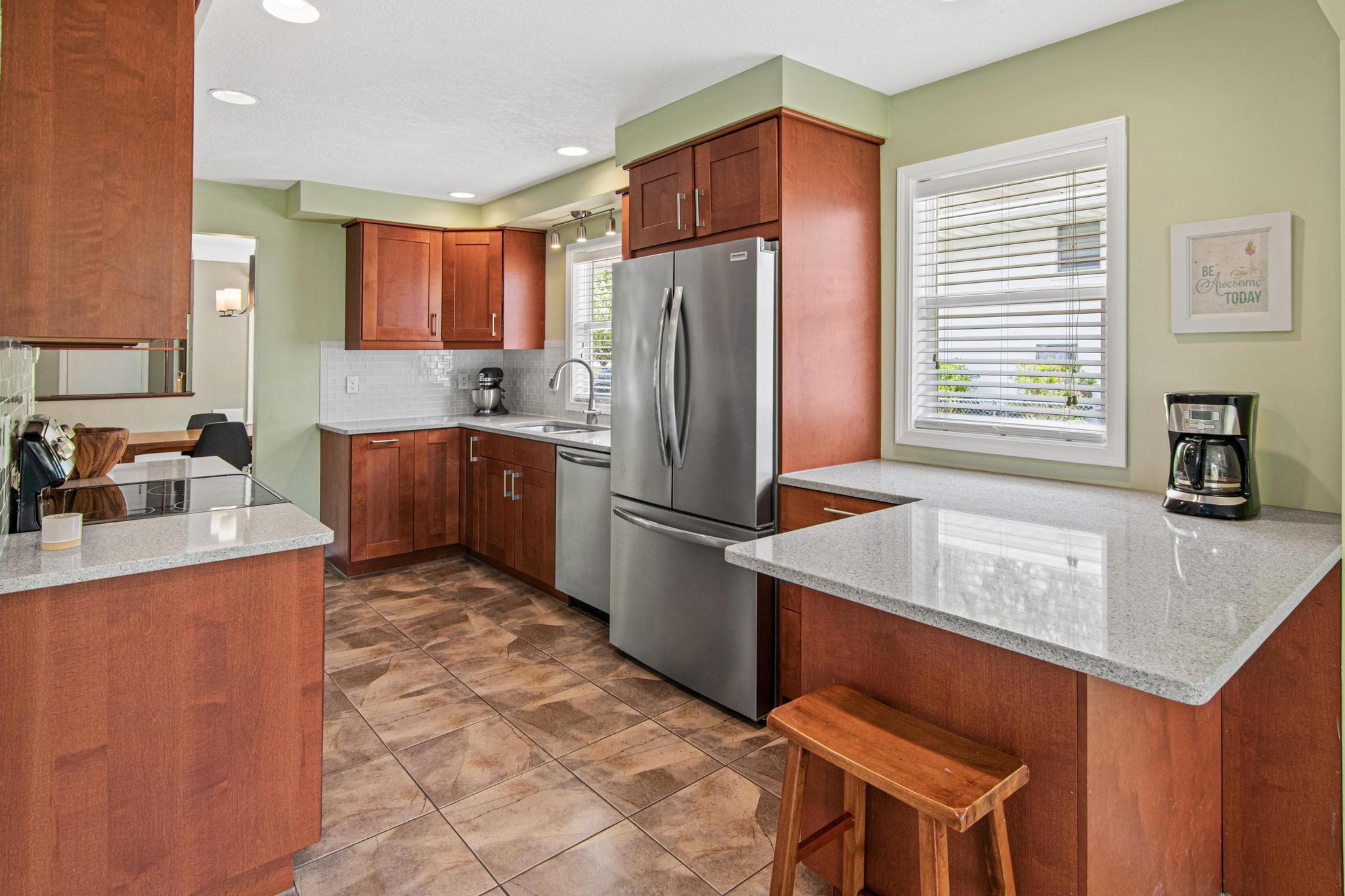 The kitchen has been completely remodeled. Expansive stone countertops provide ample prep space and an abundance of cabinetry provides excellent storage. There is a pantry closet around the corner too!
