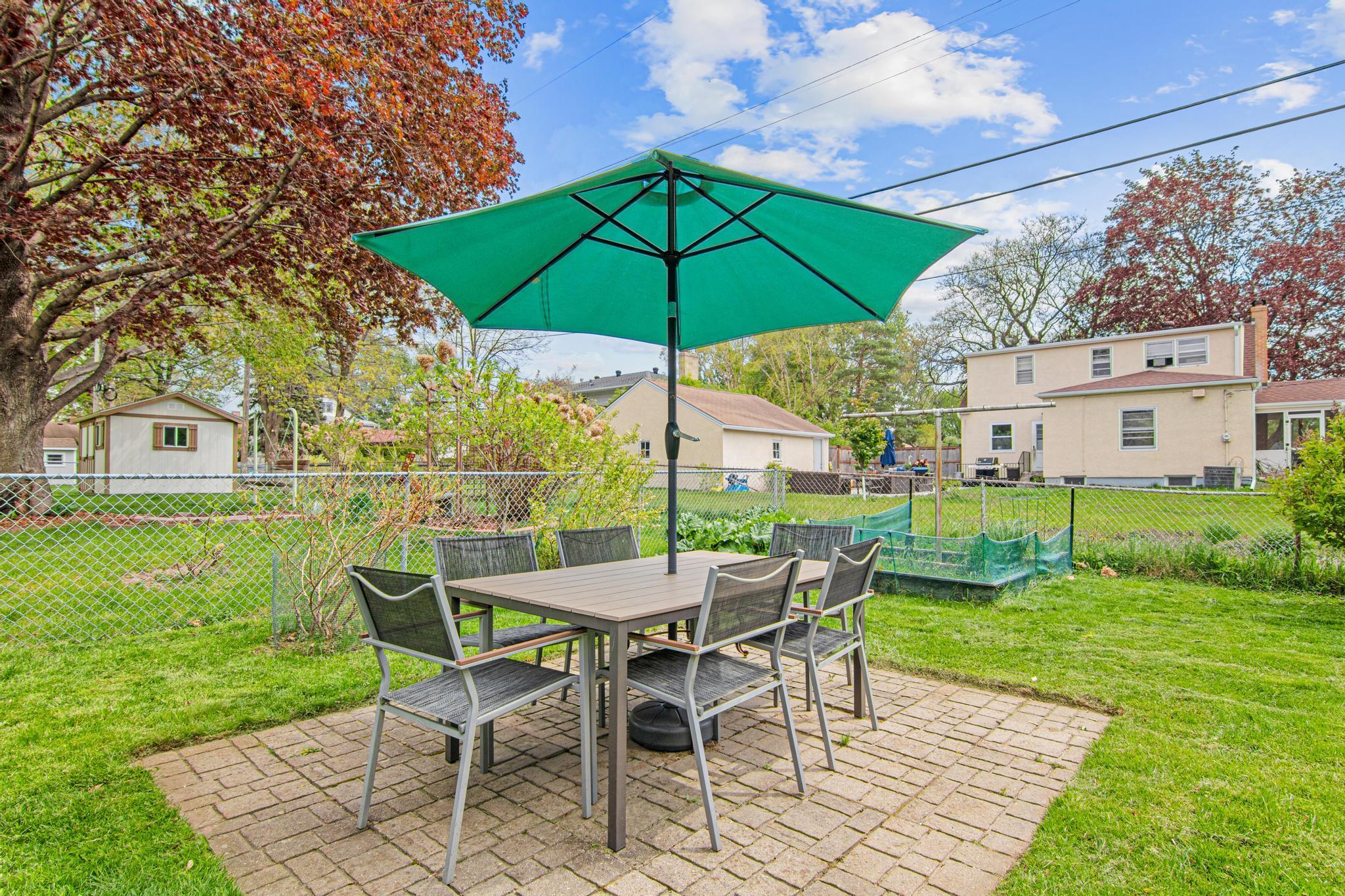 The patio is perfect for al fresco dining. You could even pick some fresh blueberries or rhubarb to make hoomegrown baked treats. The garden box has perennial mint, chives and dill.