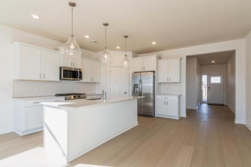 (Photo of similar home, features will vary) The spacious gourmet kitchen features a large center island, quartz countertops, stainless steel appliances, and more! **NOTE: This kitchen will be gourmet.