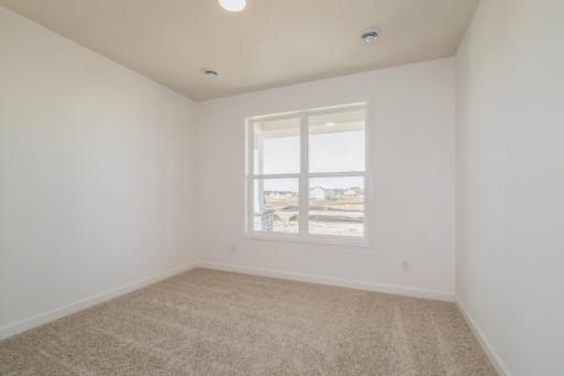 (Photo of similar home, features will vary) At the front of the home is a bedroom to accommodate visiting guests or make an at home office!