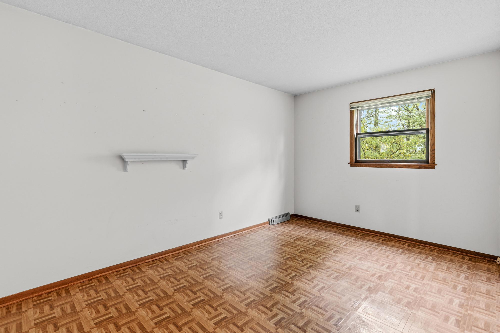 The main floor's second bedroom's window opens onto the west yard.