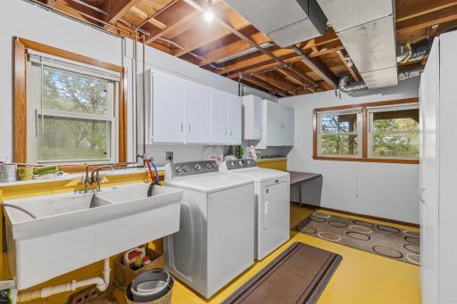 The laundry room has lots of natural light that streams in from newer windows. The washer and dryer are newer, too. This room also has loads of storage space and still room for a folding table.