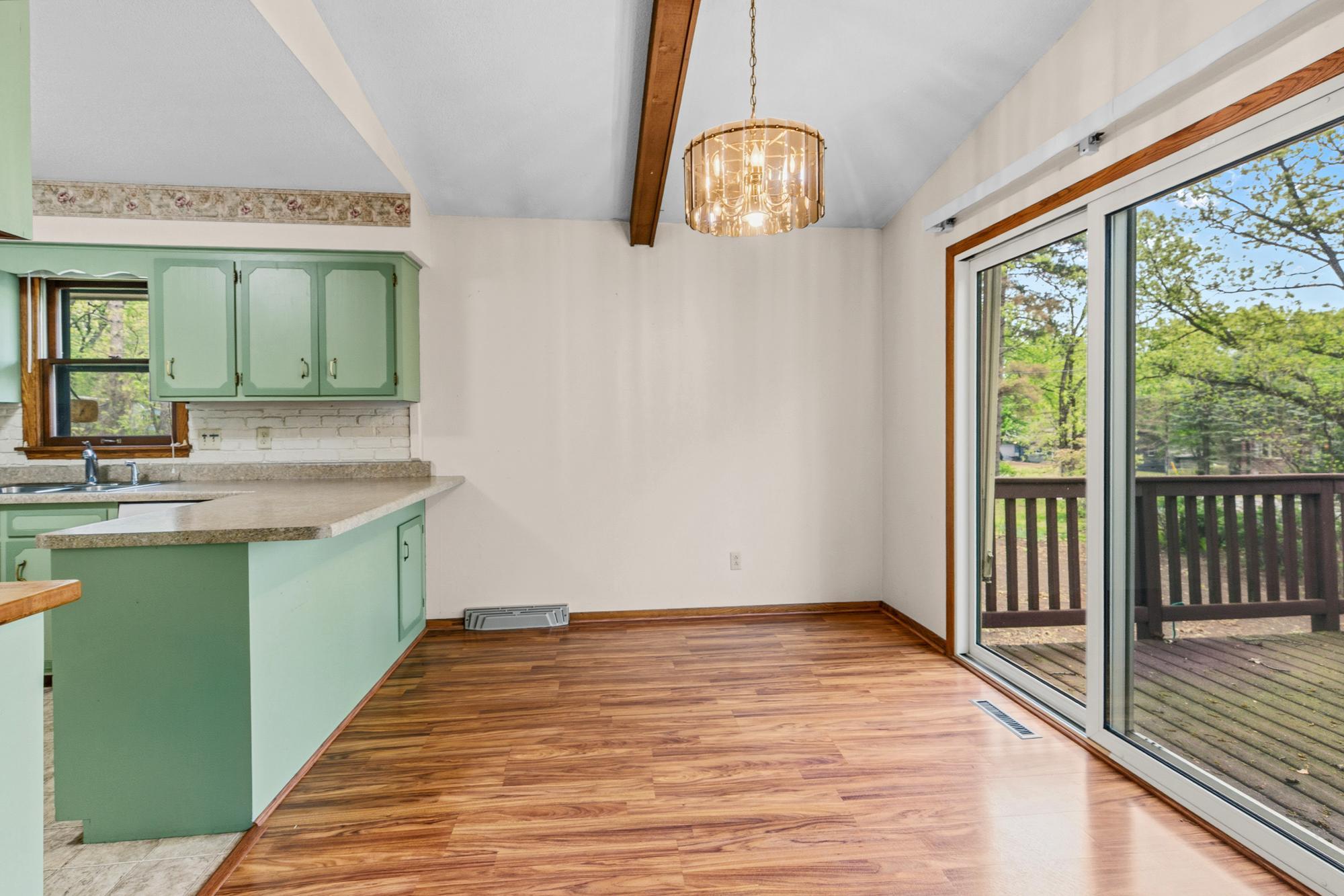 The dining area is flooded with light from the sliding glass doors. And because there are no walls blocking it from the living area, it would be easy to extend a table for larger holiday gatherings.