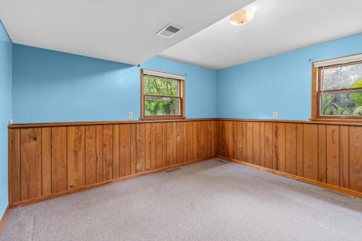 The less dramatic lower level bedroom has windows overlooking the north and west yards.
