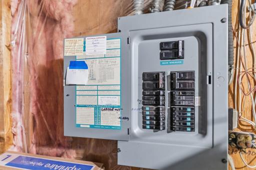 The main electrical box is located in the laundry area of the home. The secondary garage runs on a subpanel.