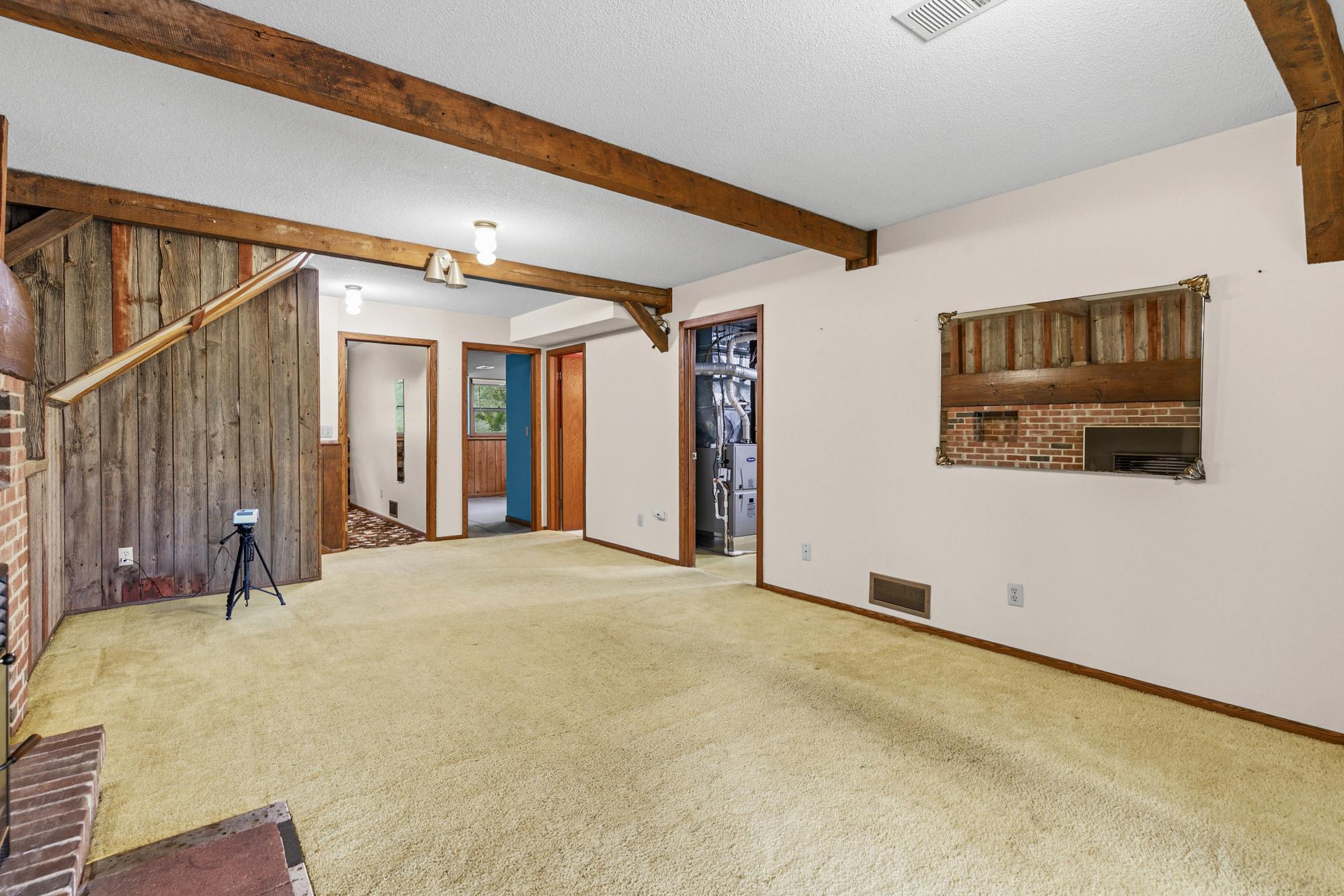 Two bedrooms, a bathroom, and a laundry/mechanical room are at the far end of the family room.