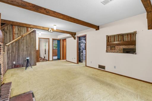 Two bedrooms, a bathroom, and a laundry/mechanical room are at the far end of the family room.