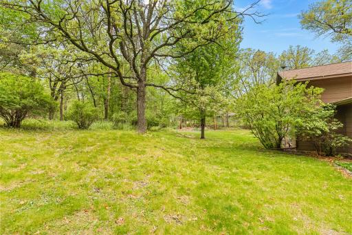 Along with many lovely trees, the property also has great outdoor living and playing spaces. This is the northside yard.