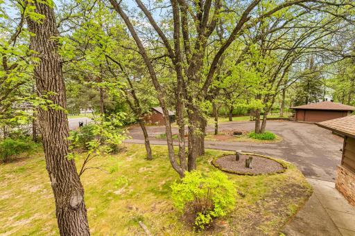 The expansive circular drive is best viewed from the south side of the home's deck. Don't miss the fire pit area inside the drive's center section.