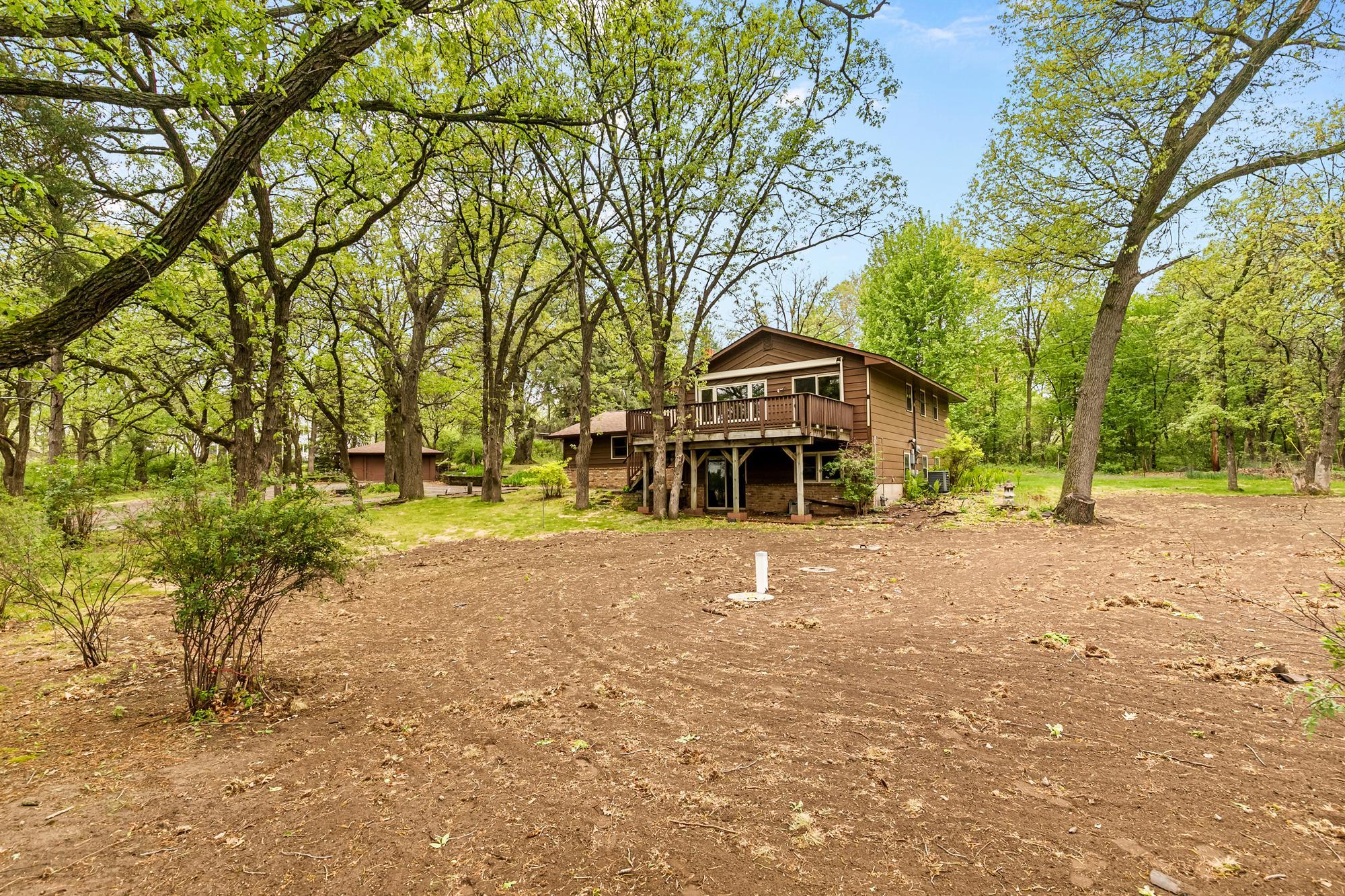 A view of the home facing west from the corner of the new drain field.