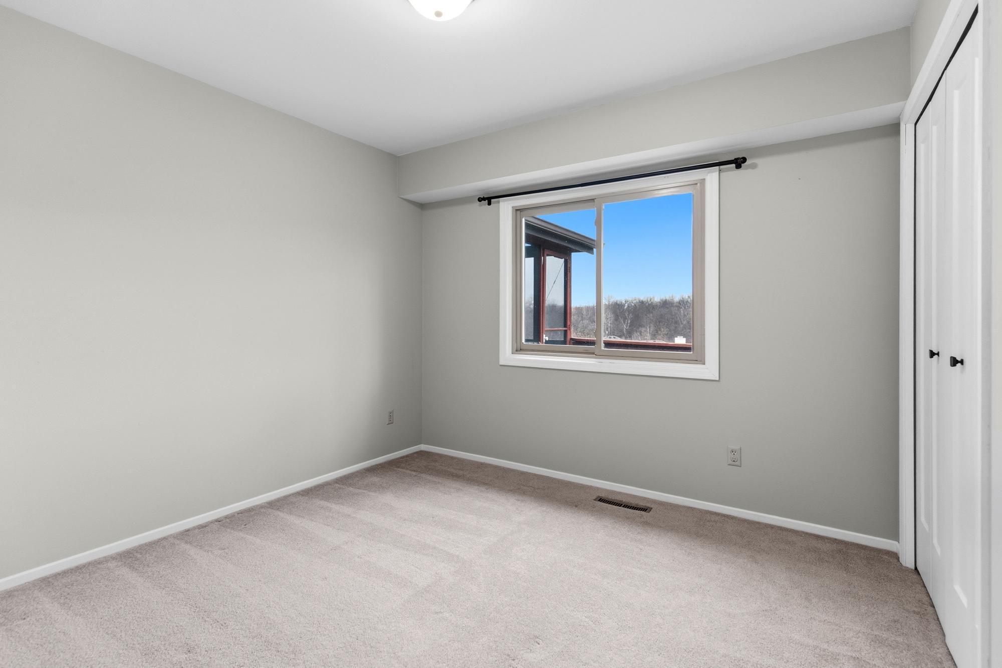 The window of this room overlooks the backyard and screened porch.
