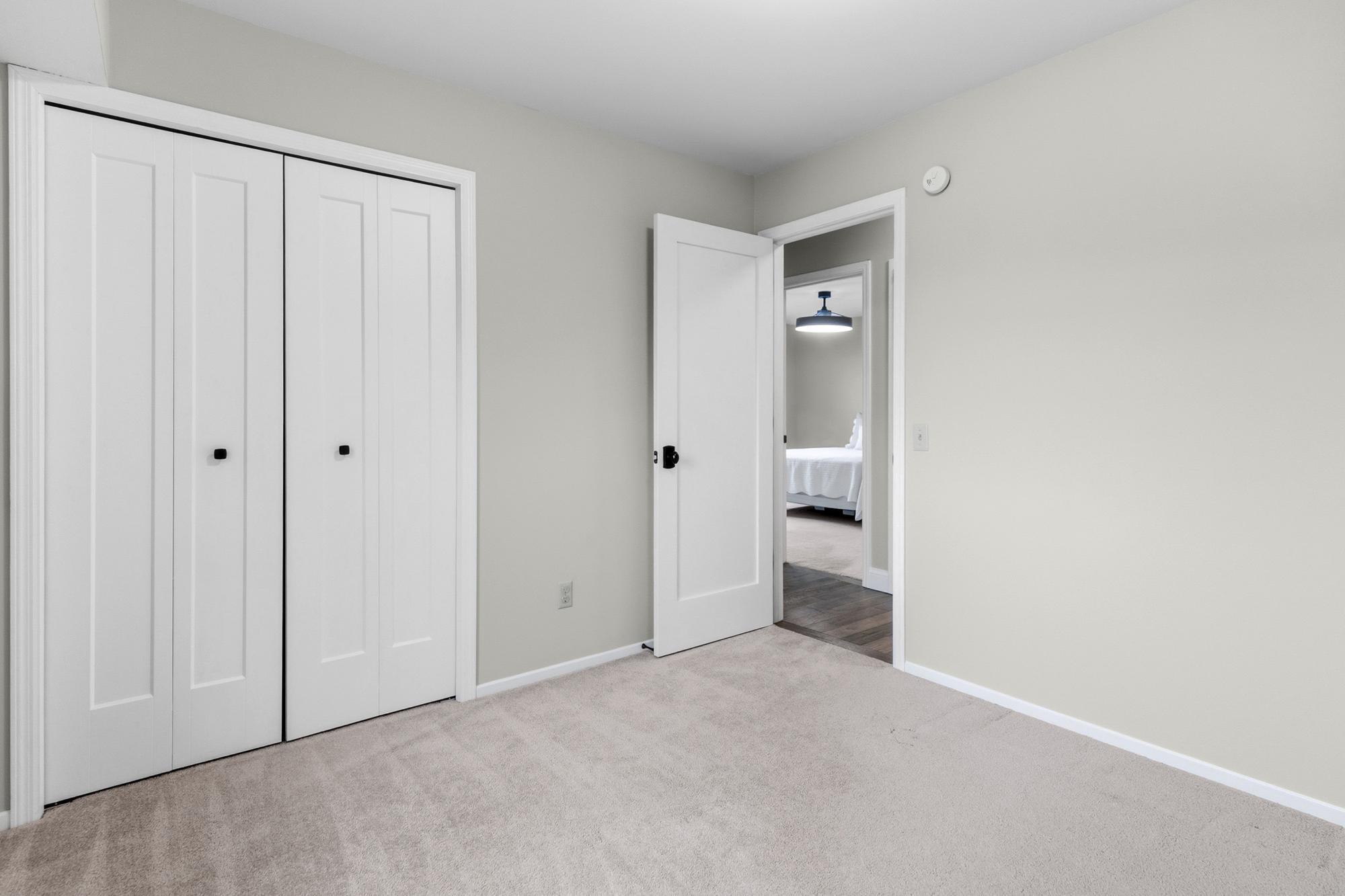 The first of two secondary bedrooms, this room sits adjacent to the second bedroom and across from the primary.