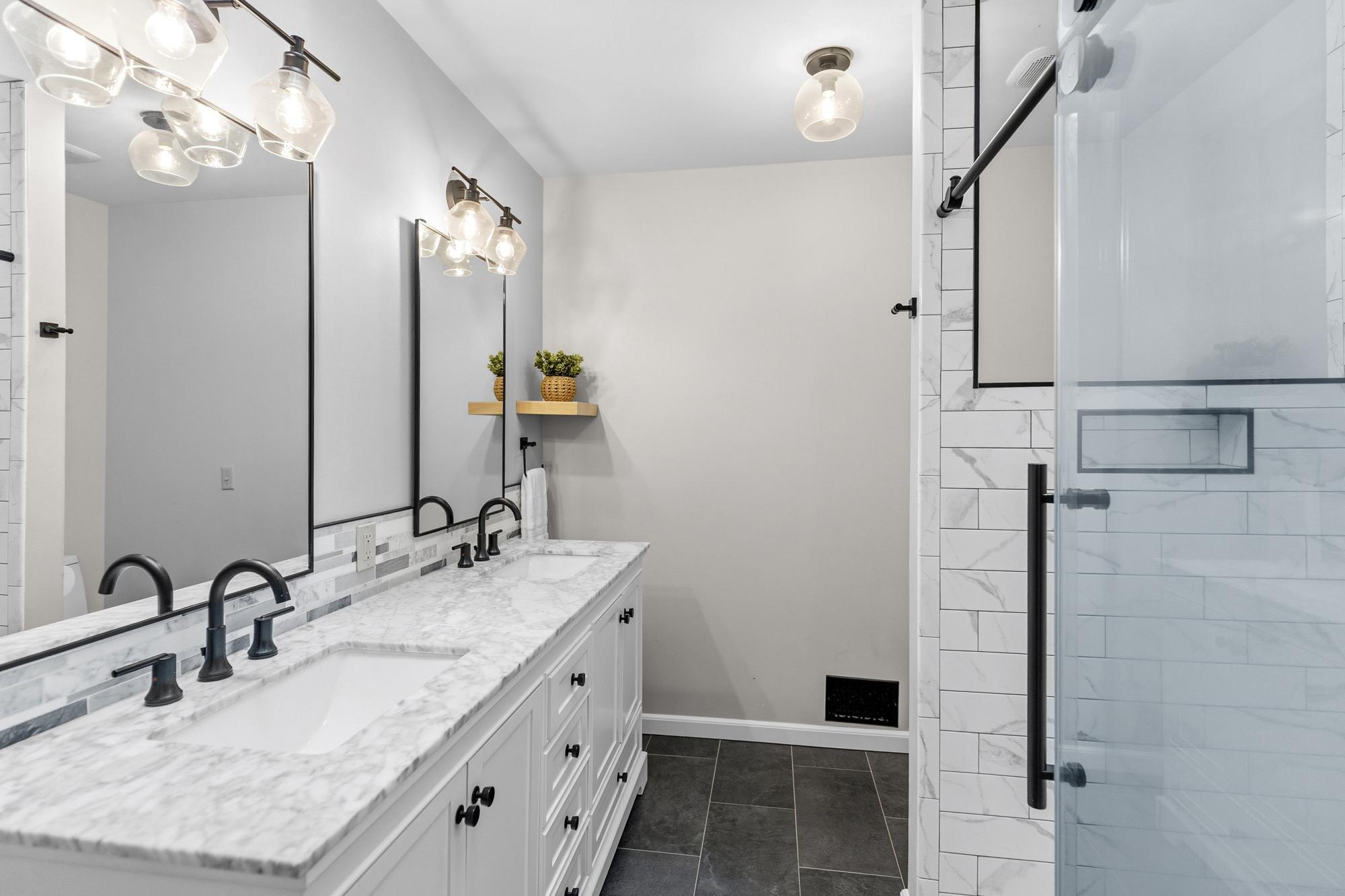 Classically tasteful choices elicite a luxury hotel spa feel in this fully renovated bath.