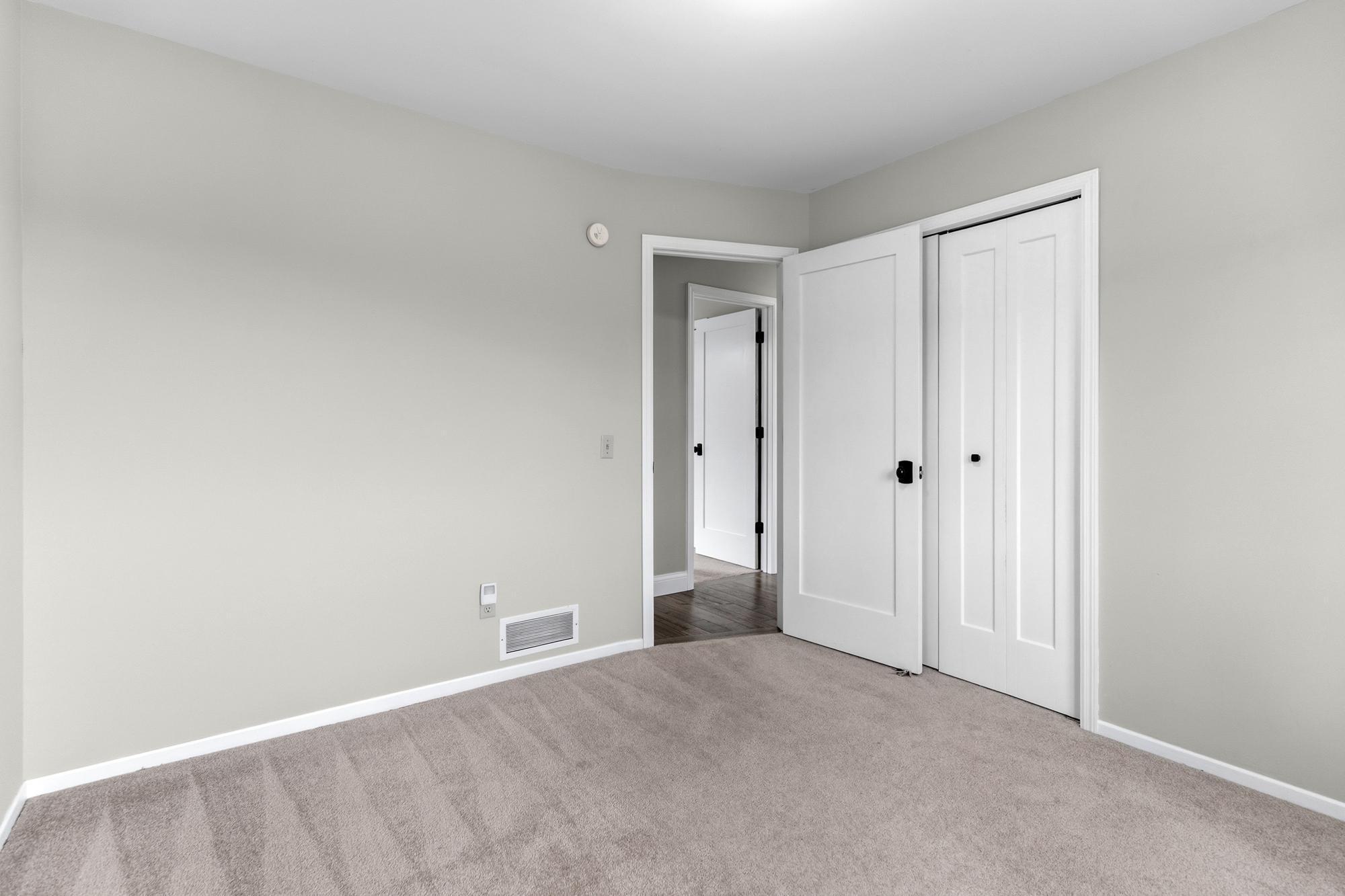 The second bedroom lies at the end of the hallway and on the same side of the home as the first bedroom.