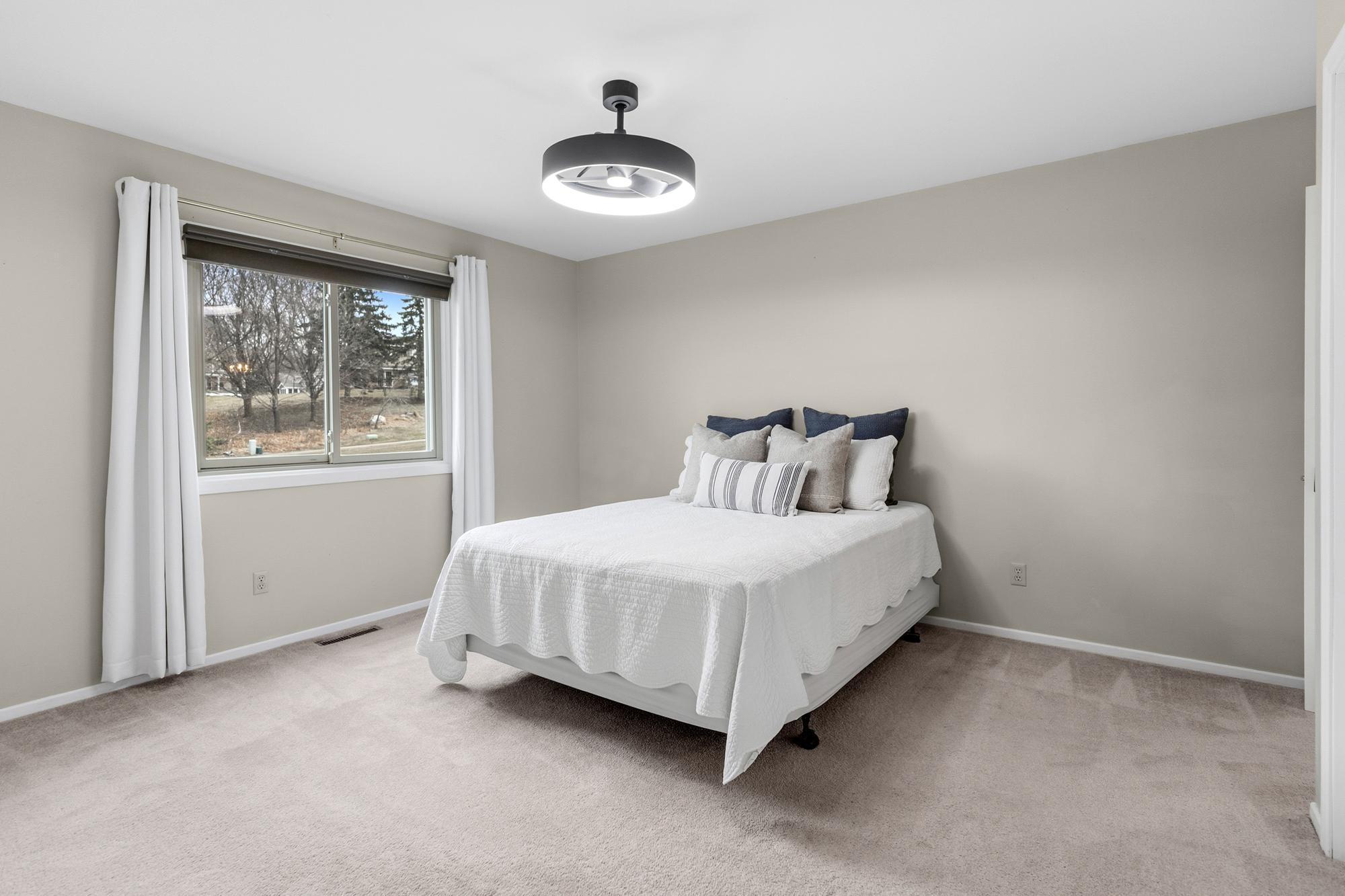 The primary bedroom sits at the end of the hall and overlooks the home's side yard. There's plenty of room in here for a king bed.
